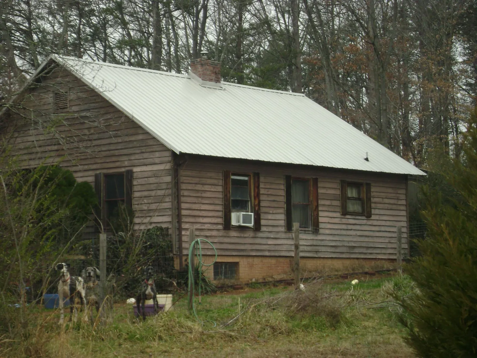 White metal roof on an old wood sided farmhouse, from a Metal Roof Installation job in Mcville
